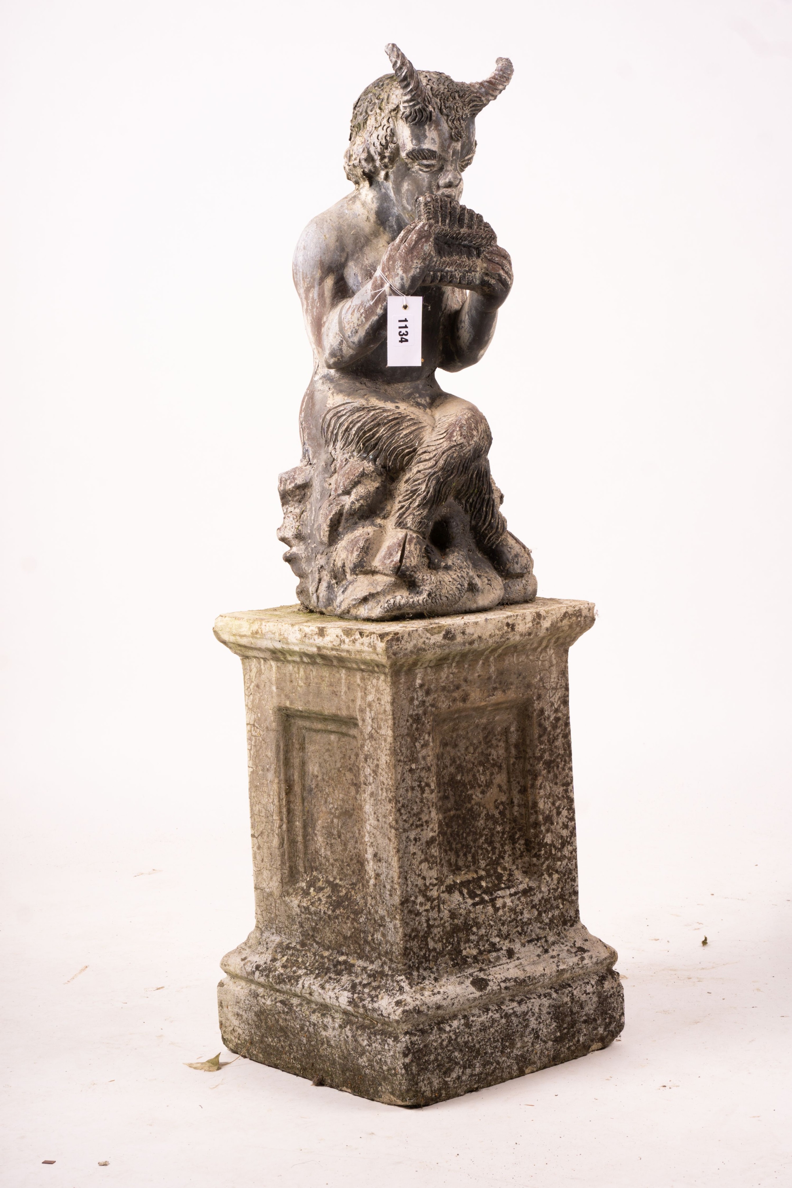 A cast lead figure, seated pan, on reconstituted concrete base, total height 107cm